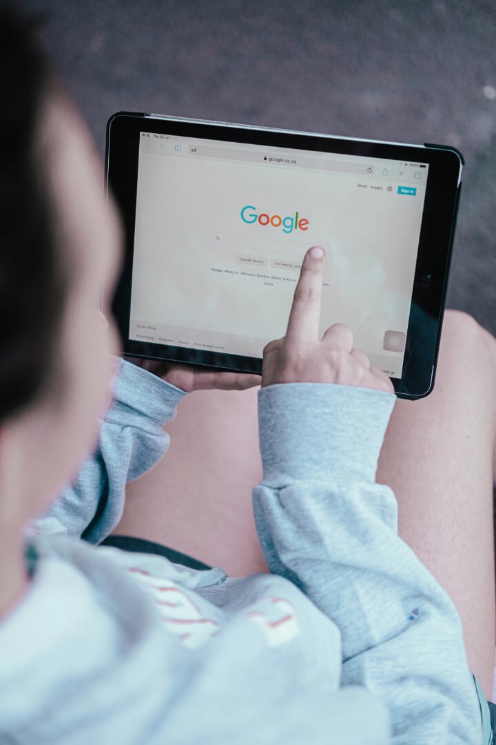 Person holding black android tablet, browsing Google - photo by Duncan Meyer